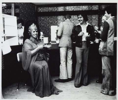 Carmen relaxing, 1970s. Her customers could indicate their sexual desires by placing their teacups in particular ways. Photography by Ans Westra. Te Papa (O.016233)
