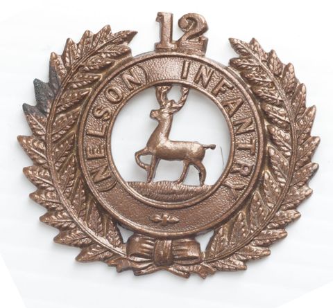 Cap badge, 12th (Nelson) Regiment, 1912-1916, United Kingdom, by J.R. Gaunt & Sons Ltd. Gift of the Defence Department, 1916. CC BY-NC-ND licence. Te Papa (GH021066)